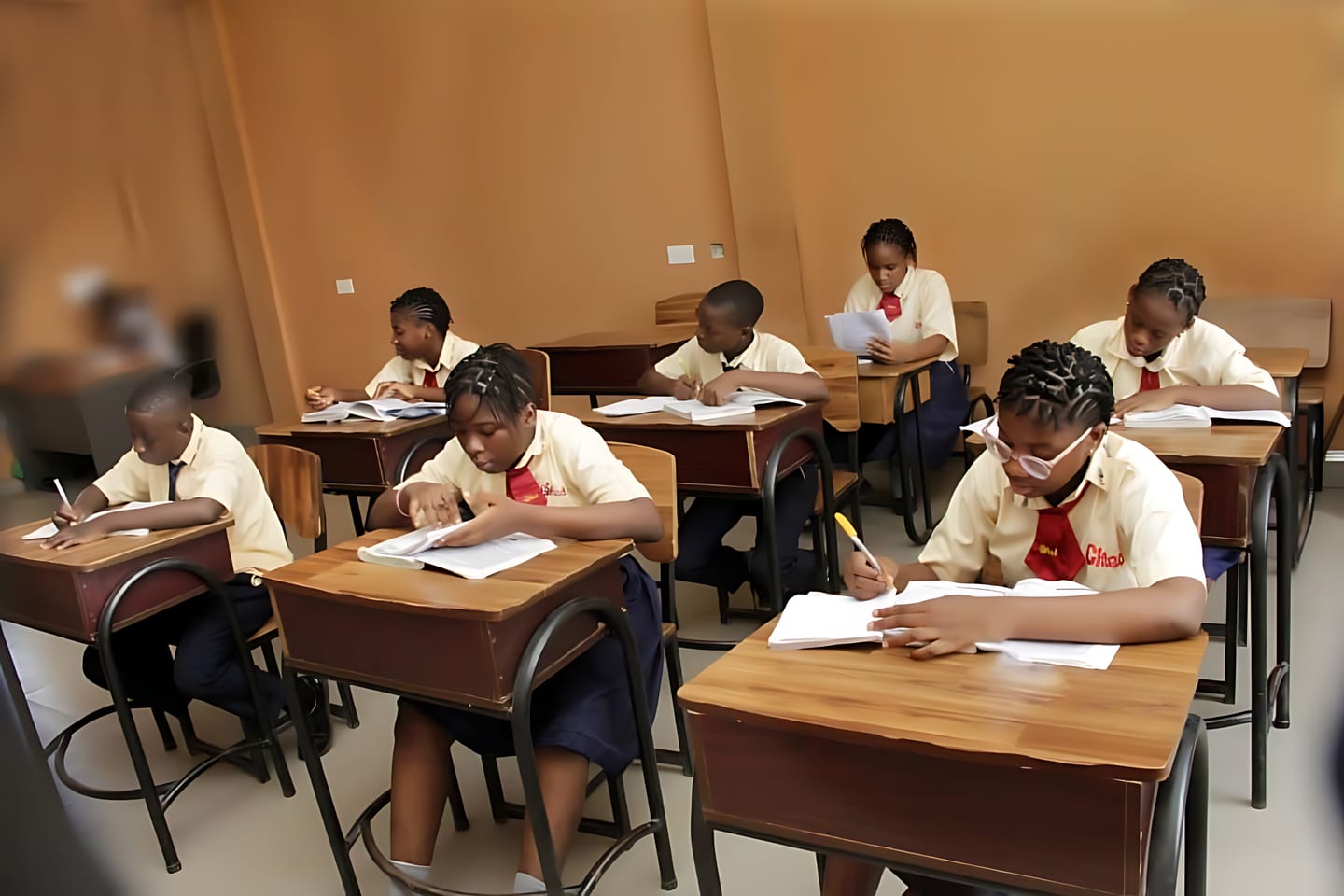Gifted Brains School Students in Cream Uniforms at Individual Desks